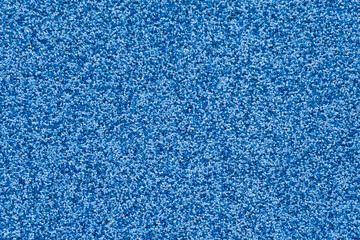 The blue wall. The texture of small stones.