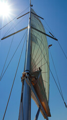 Fototapeta premium View to mast and sail on sailing boat in open sea 