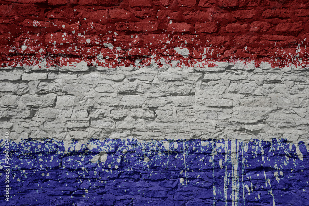 Wall mural painted big national flag of netherlands on a massive old brick wall