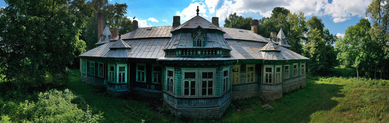 Beautiful old wooden manor in the summer in the village. Eastern Europe. aerial photography.  panorama