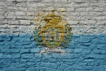 painted big national flag of san marino on a massive old brick wall