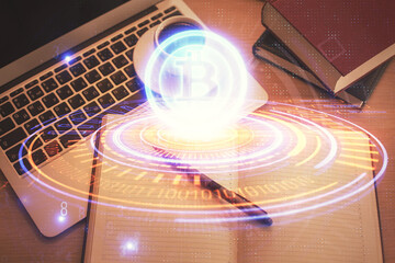 Blockchain theme hologram drawings over computer on the desktop background. Top view. Double...