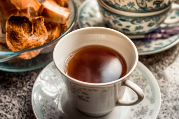 Close up cup of tea with teapot and toast for breakfast