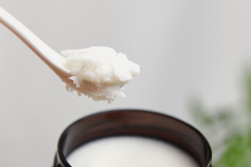 Pure shea butter in spoon. Skin and hair care product, natural cosmetics.