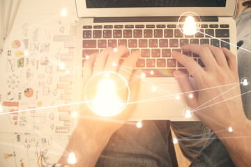 Double exposure of man's hands typing over computer keyboard and social network theme hologram drawing. Top view. People connection web concept.