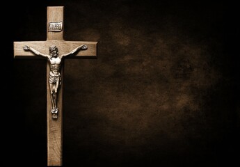Crucifix isolated on large dark brown and black mottled background
