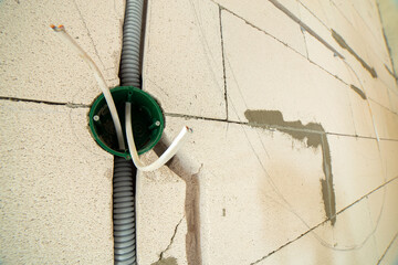 New electrical wiring installation, plastic boxe and electrical cable for future outlet sockets on...