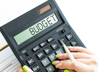 A calculator with word Budget on the display