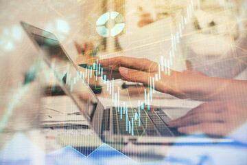 Multi exposure of woman hands typing on computer and financial graph hologram drawing. Stock market analysis concept.