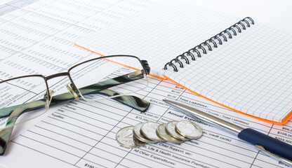Coins and glasses on the documents. Financial concept