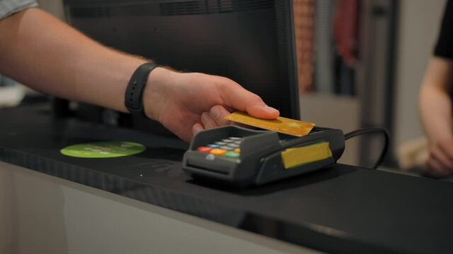 The seller gives to buyer an electronic terminal for credit and debit cards to pay for the purchase. The customer attaches a plastic card to the reader. Successful payment for purchase