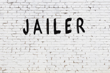 White wall with black paint inscription jailer on it