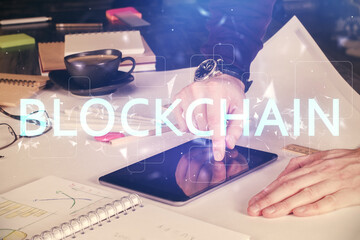 Double exposure of man's hands holding and using a phone and crypto currency blockchain theme...