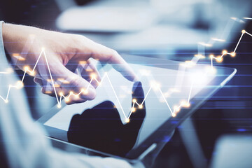 Multi exposure of man's hands holding and using a phone and financial chart drawing. Market analysis concept.