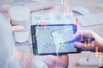 Double exposure of man's hands holding and using a phone and financial chart drawing. Market analysis concept.