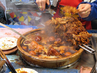 Traditional street vendor selling Pork knuckles and ginger stew
