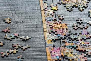 A partially completed puzzle on wood table