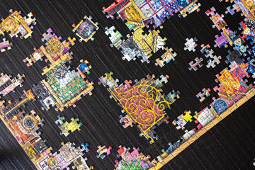 Fototapeta premium A partially completed puzzle on wood table