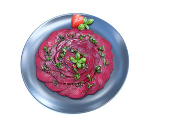 Fresh beetroot carpaccio with basil leaf, heart shaped cherry tomato.