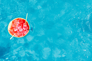watermelon cocktail floating in the pool