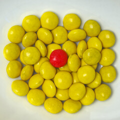 Yellow candy with a red candy in the middle making a nice contrast