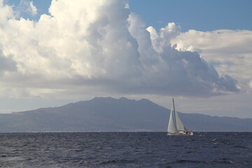 Sailing ship yachts with white sails in race the regatta in the open sea	