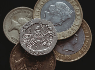 Twenty pence coin on top of other coins.
