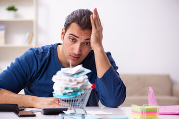 Young man in budget planning concept
