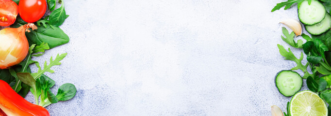 Healthy food background with various green herbs and vegetables. Ingredients for cooking salad. Vegetarian and vegan food concept. Panoramic banner with copy space