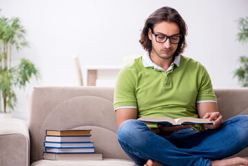 Young male student preparing for exams at home