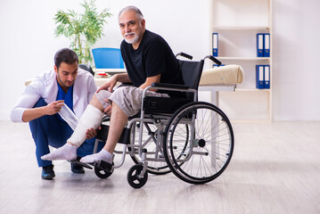 Old injured man visiting young male doctor traumatologist