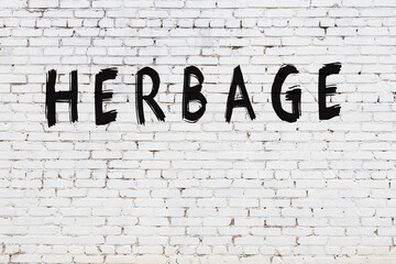 White wall with black paint inscription herbage on it