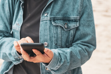 Woman using smartphone to do work business, social network, communication with beach outdoor space.