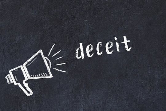 Chalk loudspeaker and inscription deceit on black chalkboard