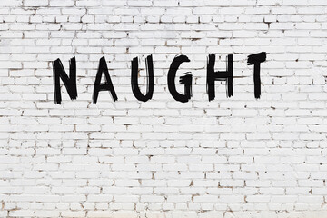 Inscription naught painted on white brick wall