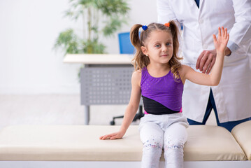 Small girl visiting young male doctor