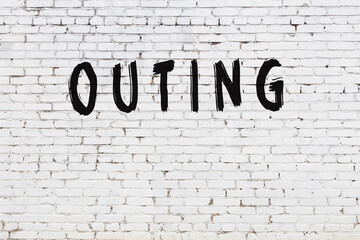 Inscription outing painted on white brick wall