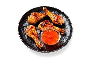 Roasted spicy chicken legs with chili sauce isolated on white background.