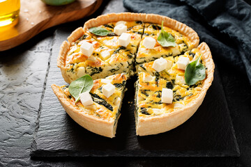Vegetarian spinach pie or quiche with feta cheese .