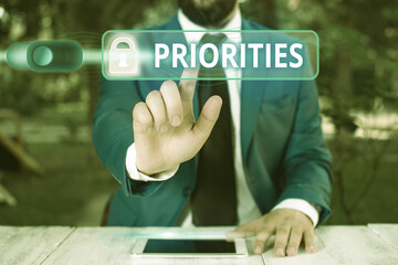 Writing note showing Priorities. Business concept for more important is the fact or state of being...