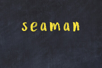 College chalk desk with the word seaman written on in