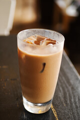 Ice Cafe coffee type in Mocha, Cappuccino serving in transparent glass and the droplet of water stream on the outside. Presenting in select spot focus and blurred with high contrast and for attractive