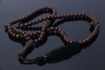 prayer beads made of wood with insulated black background. Buddhist and Muslim tools for worship....