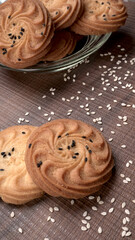 Homemade oatmeal cookies with flax and sesame seeds on white wooden table, copy space. Healthy vegan oat cookies