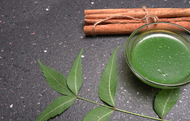 Medicinal Ayurvedic Azadirachta indica or Neem leaves with pestle with neem paste, juice and twigs.