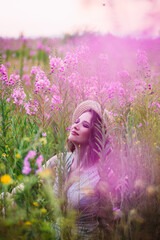 a girl in a straw hat in a field of flowers