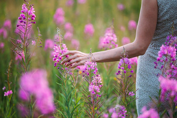 a girl in a straw hat in a field of flowers