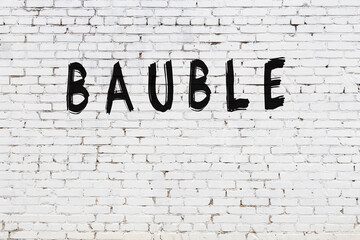 White wall with black paint inscription bauble on it