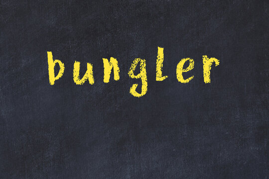 College chalk desk with the word bungler written on in