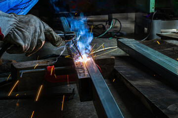 close up of welder is welding the steel in the work area.